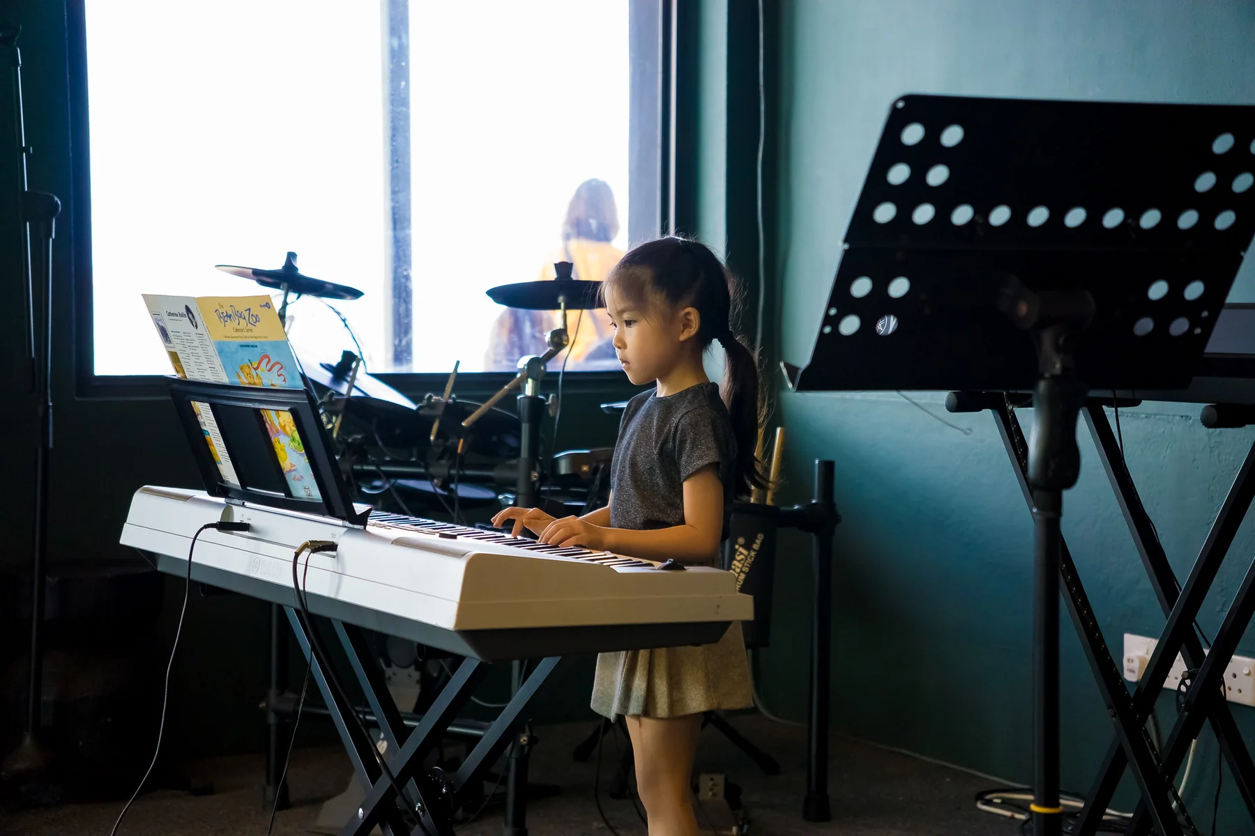 Young student playing a keyboard during an Expressivo performance