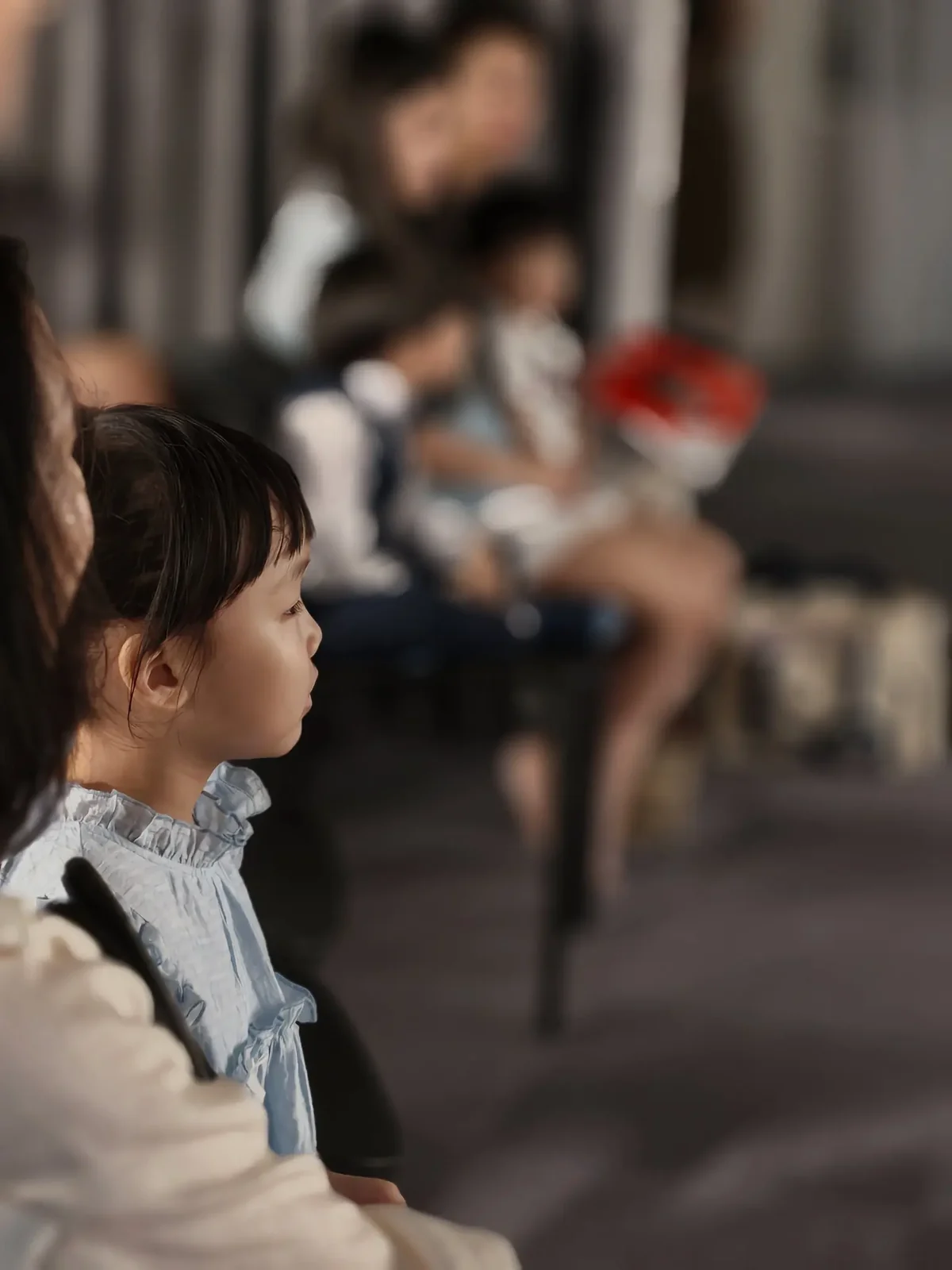 Young musician watching fellow graduates perform at the piano