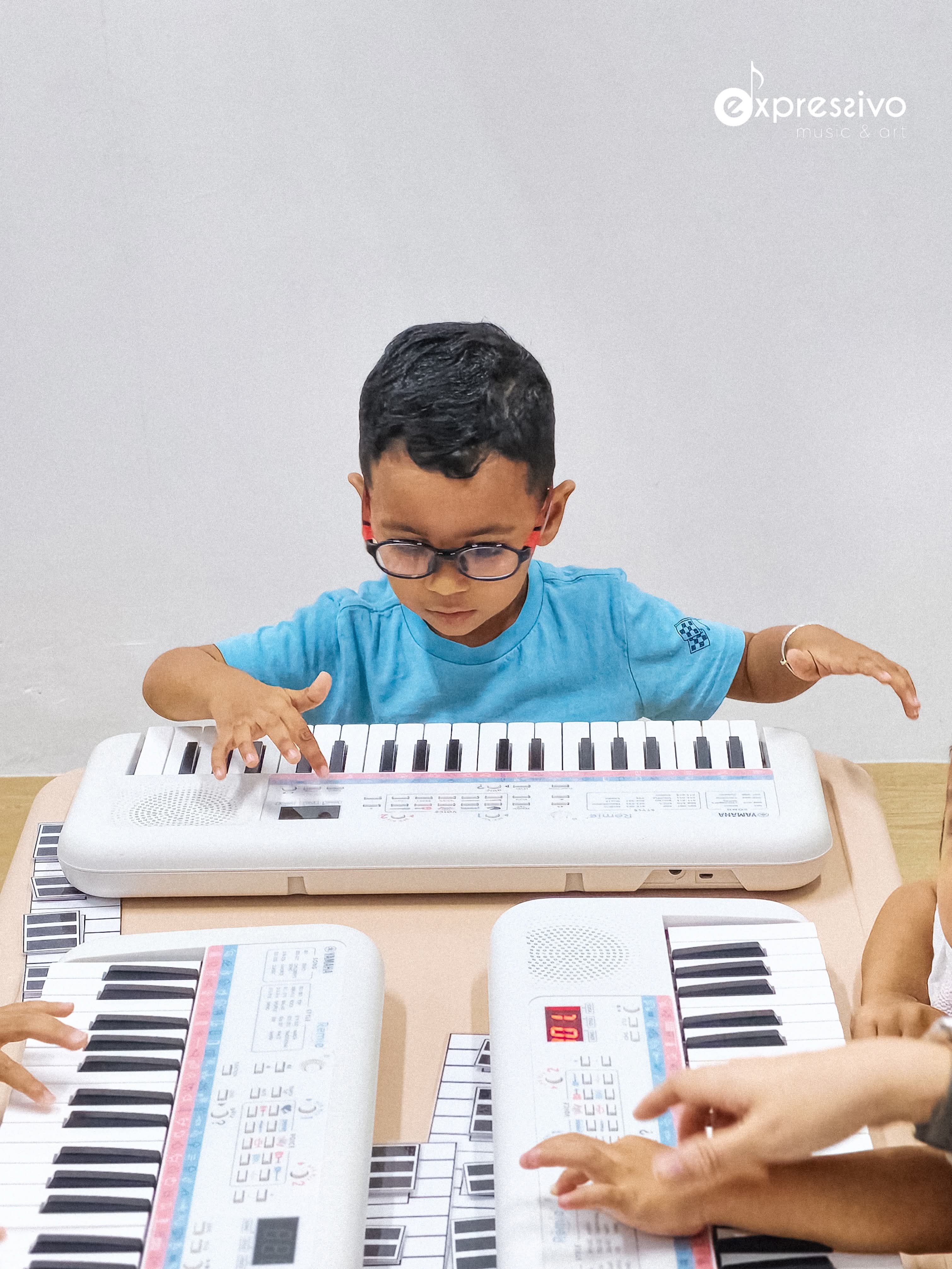 Young musician exploring melody on a keyboard
