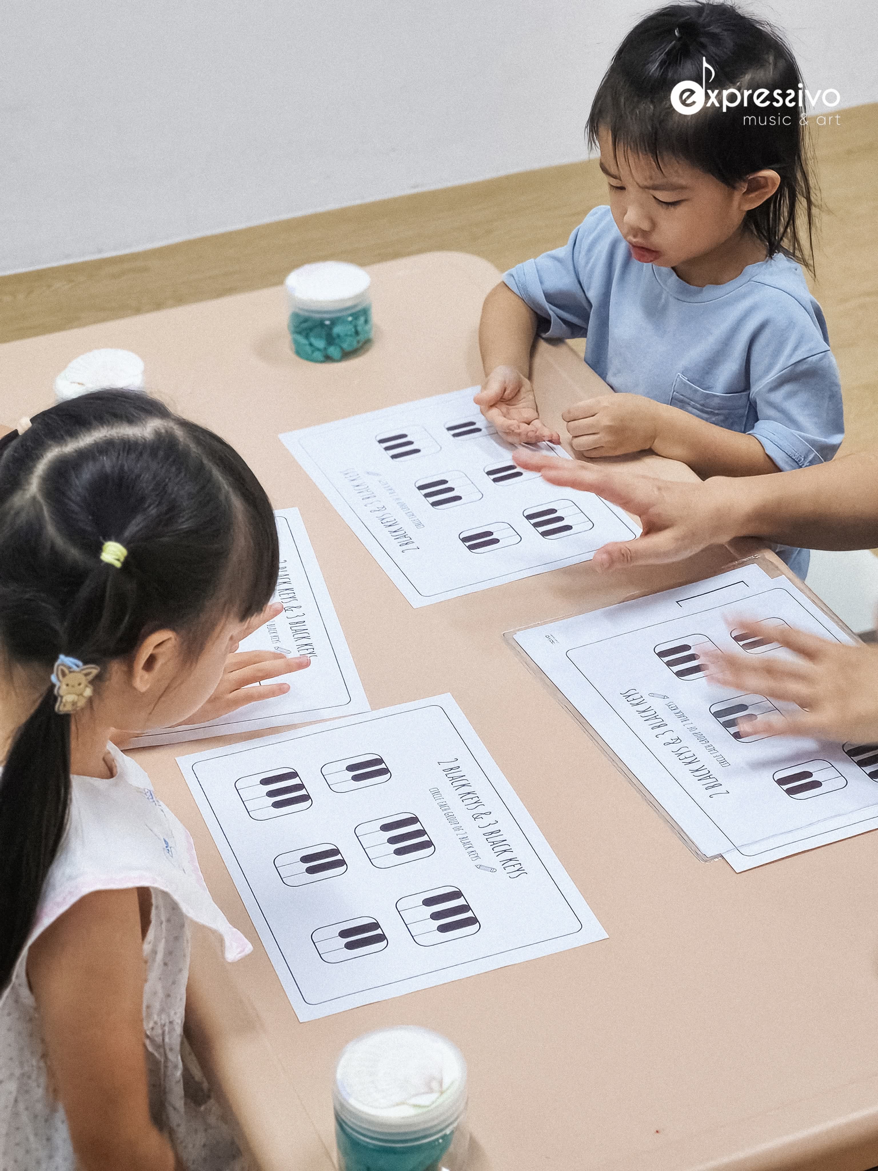 Children completing hands-on music theory activities together