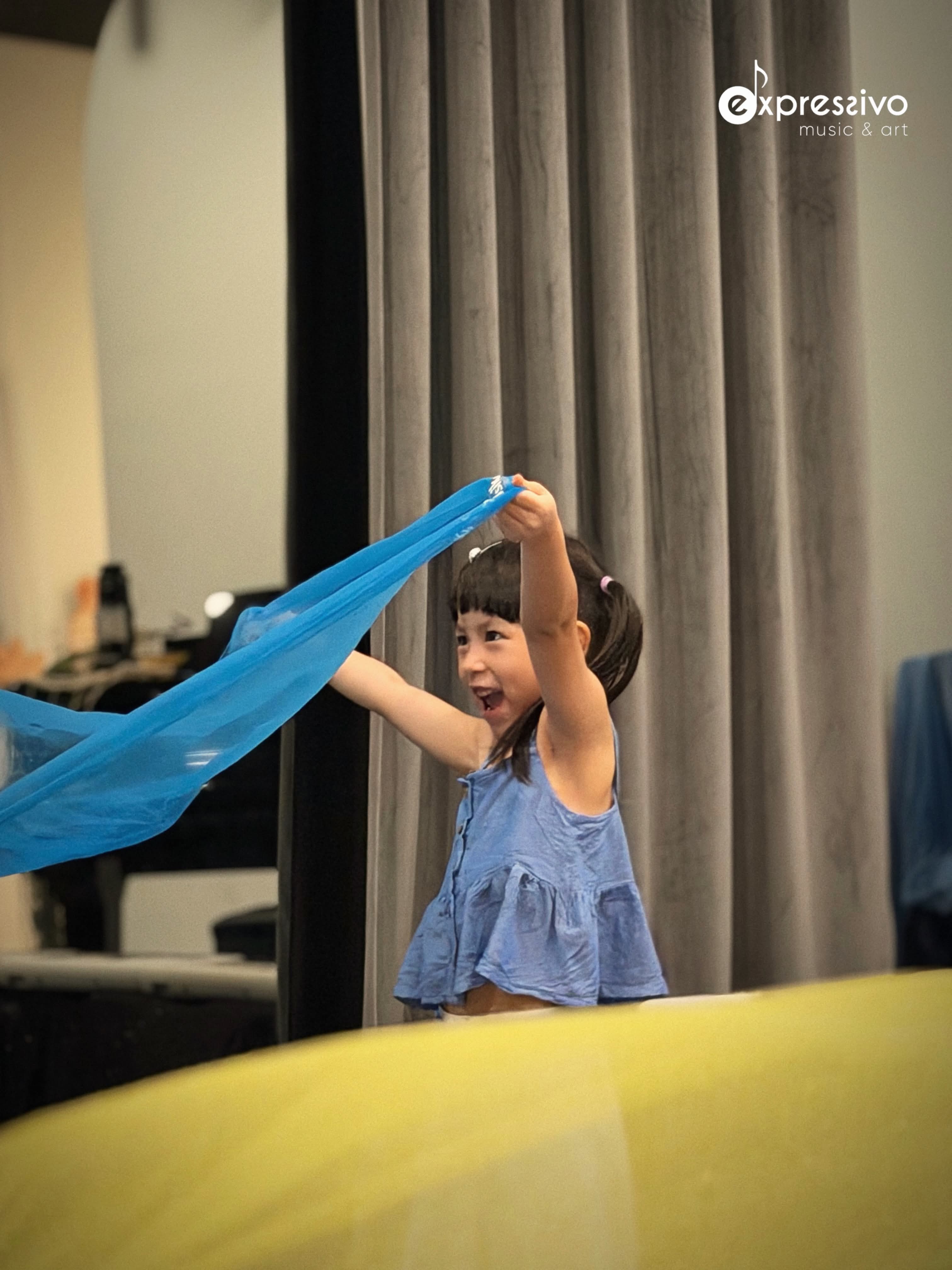 Young performer sharing joyful movement during the beach performance